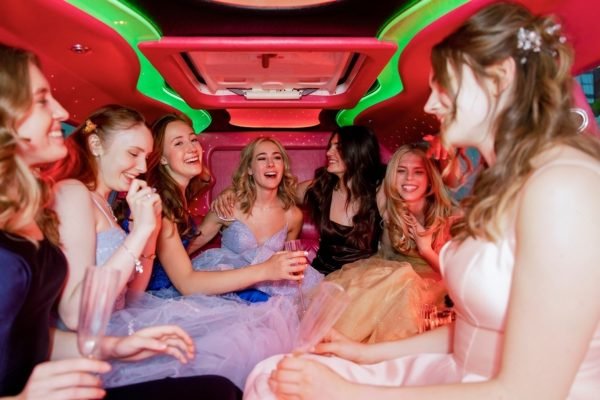 stock-photo-happy-teenage-girl-friends-laughing-in-prom-limousine-2254114629